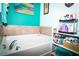 Modern bathroom with a large soaking tub and decorative shelf for toiletries and towels at 4793 Grassy Knoll Dr, Tavares, FL 32778