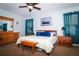Comfortable bedroom featuring wood furniture, a ceiling fan, and blue accents for a relaxing atmosphere at 4793 Grassy Knoll Dr, Tavares, FL 32778