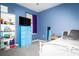 Cozy bedroom features a blue accent wall, matching dresser, and comfortable furnishings, creating a relaxing retreat at 4793 Grassy Knoll Dr, Tavares, FL 32778