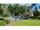 A community pool area with sun loungers and a charming yellow pavilion, offering a relaxing outdoor space at 4793 Grassy Knoll Dr, Tavares, FL 32778