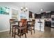 Dining area with pendant lighting open to the kitchen, featuring a breakfast bar and matching dark wood cabinets at 4793 Grassy Knoll Dr, Tavares, FL 32778