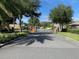 Gated community entrance with well-manicured landscaping providing privacy and security for residents at 4793 Grassy Knoll Dr, Tavares, FL 32778