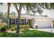 Charming single-story home with a well-manicured lawn and attached two car garage at 4793 Grassy Knoll Dr, Tavares, FL 32778