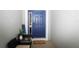 Inviting front entryway features a stylish blue door with a charming welcome mat and tasteful decorations at 4793 Grassy Knoll Dr, Tavares, FL 32778