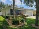 Quaint single-story home with well-kept lawn, mature landscaping, and an attached two-car garage at 4793 Grassy Knoll Dr, Tavares, FL 32778