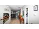 Welcoming hallway with tile floors leads to the living area with comfortable leather seating, and convenient laundry room at 4793 Grassy Knoll Dr, Tavares, FL 32778