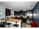 A spacious kitchen featuring dark wood cabinets, stainless steel appliances, and a breakfast bar with stools at 4793 Grassy Knoll Dr, Tavares, FL 32778