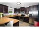 Kitchen featuring dark wood cabinets, stainless steel appliances, and stylish countertops at 4793 Grassy Knoll Dr, Tavares, FL 32778