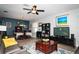 Open-concept living area with a dining table and TV; seamlessly combining living, dining, and entertainment spaces at 4793 Grassy Knoll Dr, Tavares, FL 32778
