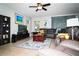 Spacious living room features a comfortable leather sectional, stylish decor, and plenty of natural light at 4793 Grassy Knoll Dr, Tavares, FL 32778