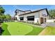 Beautiful backyard view showcasing a putting green, enhancing the appeal of outdoor entertainment and recreation at 5525 Isleworth Country Club Dr, Windermere, FL 34786