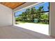 Expansive backyard view from open doorway highlighting landscaped greenery and modern design at 5525 Isleworth Country Club Dr, Windermere, FL 34786