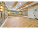 Spacious basement featuring wood floors, recessed lighting, wood ceiling beams, and decorative wall panels at 5525 Isleworth Country Club Dr, Windermere, FL 34786