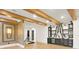 Basement featuring a bar area with a sink, cabinetry, wine fridge, and wood beam accents at 5525 Isleworth Country Club Dr, Windermere, FL 34786