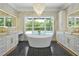 Luxurious bathroom with a freestanding tub, black and white patterned floors, and a gorgeous chandelier at 5525 Isleworth Country Club Dr, Windermere, FL 34786