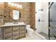 Stylish bathroom with vanity, patterned wallpaper, and glass-enclosed shower at 5525 Isleworth Country Club Dr, Windermere, FL 34786