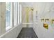 Elegant walk-in shower showcasing marble walls, black and white patterned tile floor, and gold accents at 5525 Isleworth Country Club Dr, Windermere, FL 34786