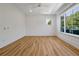 Bright and airy bedroom featuring wood floors, white walls, ceiling fan and large picture windows at 5525 Isleworth Country Club Dr, Windermere, FL 34786