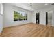 Spacious bedroom with wood floors, large window, and access to the en-suite bath and walk-in closet at 5525 Isleworth Country Club Dr, Windermere, FL 34786