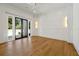 Bright bedroom with hardwood floors, white panel walls, and sliding glass doors to the outside at 5525 Isleworth Country Club Dr, Windermere, FL 34786