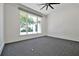 Versatile room featuring plush carpet, large window, and ceiling fan with views of the home's exterior at 5525 Isleworth Country Club Dr, Windermere, FL 34786