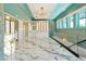 An elegant custom designed closet features white marble floors and custom storage options at 5525 Isleworth Country Club Dr, Windermere, FL 34786
