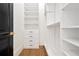 Organized walk-in closet with built-in shelving and drawers for storage at 5525 Isleworth Country Club Dr, Windermere, FL 34786