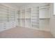 Large walk-in closet features built-in shelving and drawers for maximum storage at 5525 Isleworth Country Club Dr, Windermere, FL 34786