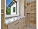 Well-organized closet boasts marble countertops and custom wood shelving for optimal storage at 5525 Isleworth Country Club Dr, Windermere, FL 34786