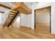 Elegant entryway with floating staircase, wood floors, and contemporary finishes, creating a grand welcome at 5525 Isleworth Country Club Dr, Windermere, FL 34786