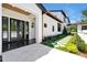 Modern home with white exterior, black trim, and landscaped walkway to the entrance at 5525 Isleworth Country Club Dr, Windermere, FL 34786