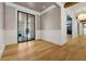 Elegant foyer showcasing wainscoting, hardwood floors, and glass paneled doors leading to outdoor views at 5525 Isleworth Country Club Dr, Windermere, FL 34786