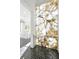 Bright hallway featuring a custom marble accent wall and geometric tile flooring at 5525 Isleworth Country Club Dr, Windermere, FL 34786