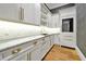 Kitchenette featuring modern white cabinets, gold hardware, and marble countertops at 5525 Isleworth Country Club Dr, Windermere, FL 34786