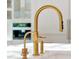 Close-up of the kitchen's elegant gold faucet and stylish countertop at 5525 Isleworth Country Club Dr, Windermere, FL 34786