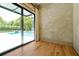 Living room with a wall of glass providing views of the pool and backyard area at 5525 Isleworth Country Club Dr, Windermere, FL 34786
