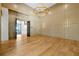 Spacious living room with hardwood floors, paneled walls, and designer lighting, offers a blend of comfort and sophistication at 5525 Isleworth Country Club Dr, Windermere, FL 34786