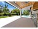 Covered outdoor living space with kitchen, pool view and wood plank ceiling at 5525 Isleworth Country Club Dr, Windermere, FL 34786