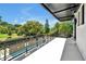 Spacious covered patio offers outdoor views with decorative railings overlooking lush greenery at 5525 Isleworth Country Club Dr, Windermere, FL 34786