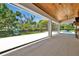 Open patio with glass walls offering a beautiful view of the garden, pool and outdoor art at 5525 Isleworth Country Club Dr, Windermere, FL 34786