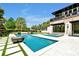 Backyard view of the pool and modern designed home at 5525 Isleworth Country Club Dr, Windermere, FL 34786