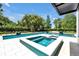 Beautiful backyard featuring a large pool, spa, and lush landscaping, perfect for relaxation and entertainment at 5525 Isleworth Country Club Dr, Windermere, FL 34786