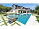 Beautiful pool area with modern tile design, fire bowls, and spacious backyard at 5525 Isleworth Country Club Dr, Windermere, FL 34786