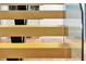 Close-up of modern staircase with wooden treads and glass railings at 5525 Isleworth Country Club Dr, Windermere, FL 34786