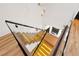View of a modern glass staircase with wooden treads and illuminated steps at 5525 Isleworth Country Club Dr, Windermere, FL 34786