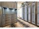 Elegant walk-in closet with custom wood cabinets and drawers with under-cabinet lighting at 5525 Isleworth Country Club Dr, Windermere, FL 34786