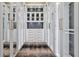 Spacious walk-in closet with custom white cabinets and drawers, plus display cabinets at 5525 Isleworth Country Club Dr, Windermere, FL 34786