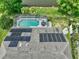 This aerial view showcases a screened pool, a patio, and solar panels on the roof at 633 Lakehaven Cir, Orlando, FL 32828