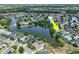 Aerial view of a home located on a lake with mature trees and neighborhood views at 633 Lakehaven Cir, Orlando, FL 32828