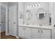 Bathroom featuring a double vanity, modern fixtures, round mirrors and gray and white walls at 633 Lakehaven Cir, Orlando, FL 32828